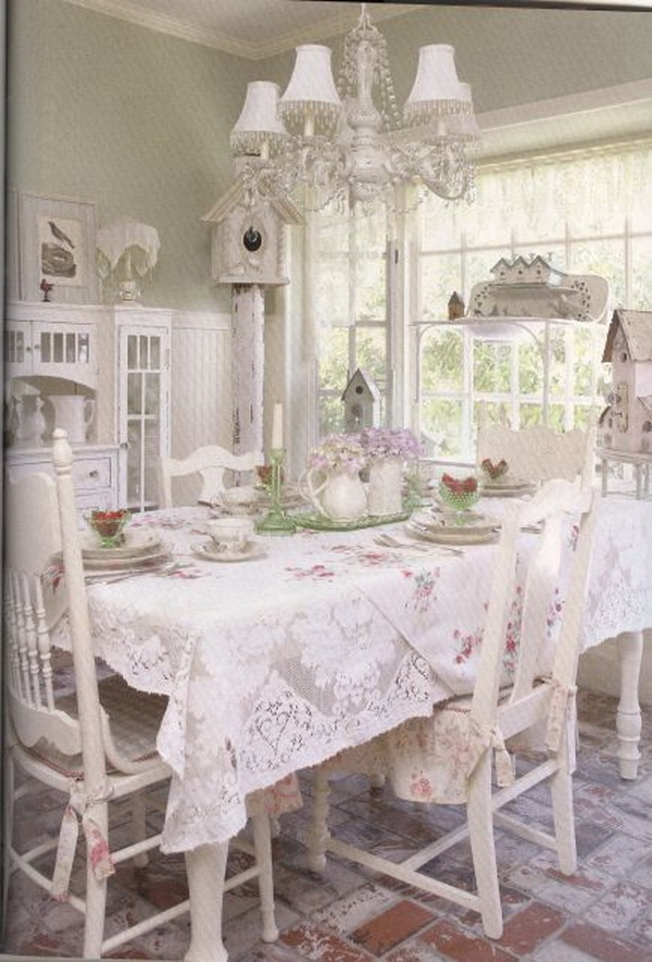 Vintage shabby chic dining room with lace tablecloth. 