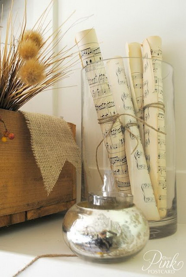 Hurricane Vase with Rolled Music Sheet. Rolled up sheet music,  tied with twin and placed in a vase, to create a unique home decor.