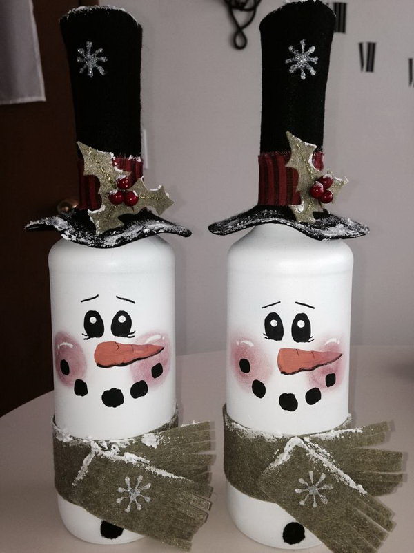 DIY Snowman Painted Wine Bottles. Easily repurpose the emtpy wine bottles with paint into colorful home accents such as these cutest snowman painted wine bottles.