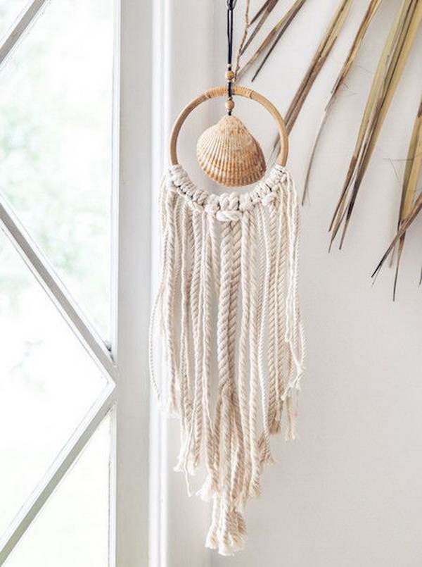 Beach Shack Wall Hanger. This gorgeous wall hanger is made with a beautiful sea shell at the center of a rattan hoop, adorned with chunky seaside style ropes! It creates a beach vibe to your decor during this summer. The supplies are also easy to find.