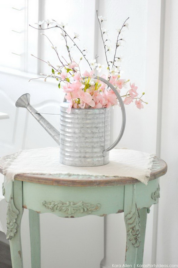 Spring Watering Can Floral Centerpiece. Create this beautiful spring centerpiece by upcycling an old watering canwith spring fresh flowers. Love how it easy to make and how it comes out for my spring home decoration!